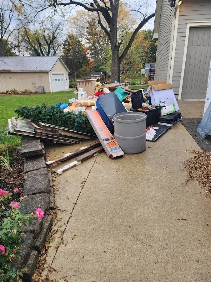 Dumpster being loaded with debris for Estate Cleanout Dumpster Rental in Littlefield